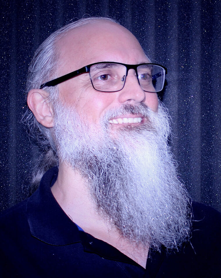 A man with long white beard and glasses.
