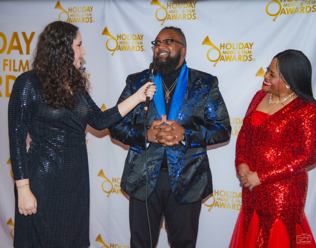 A man and two women are talking to each other.