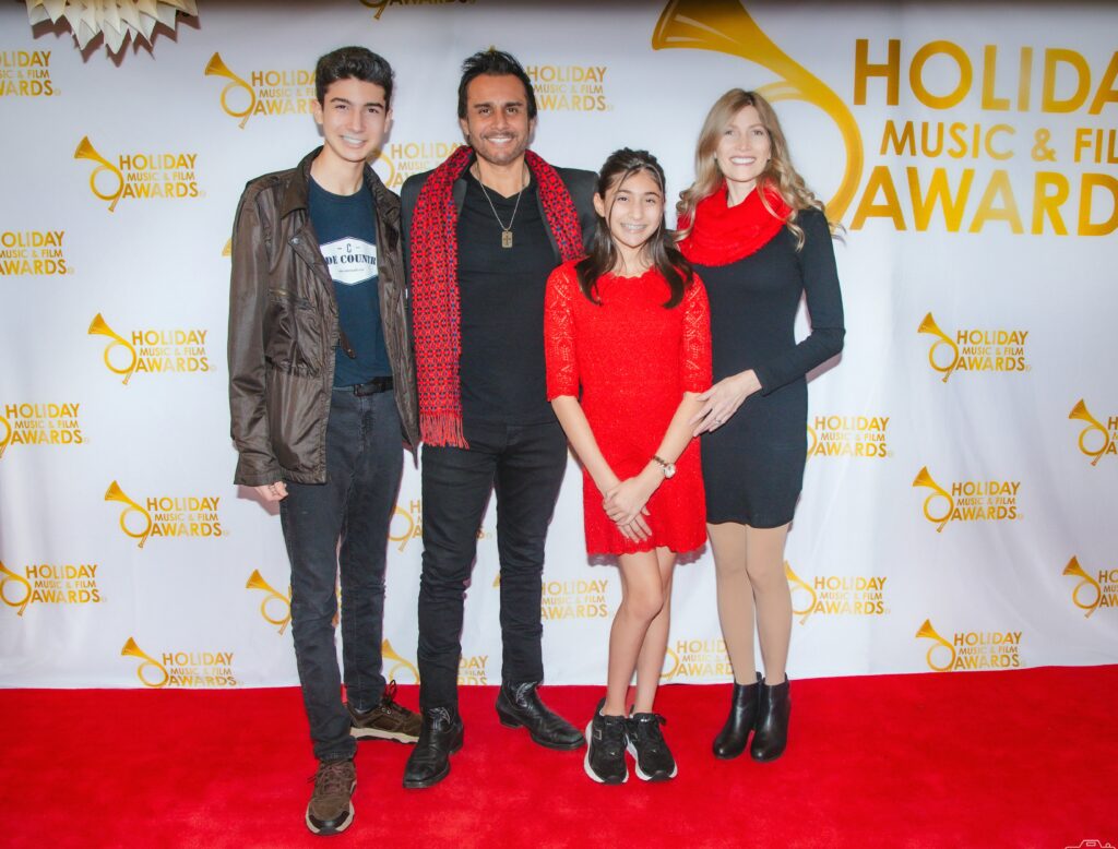 A group of people standing on the red carpet.