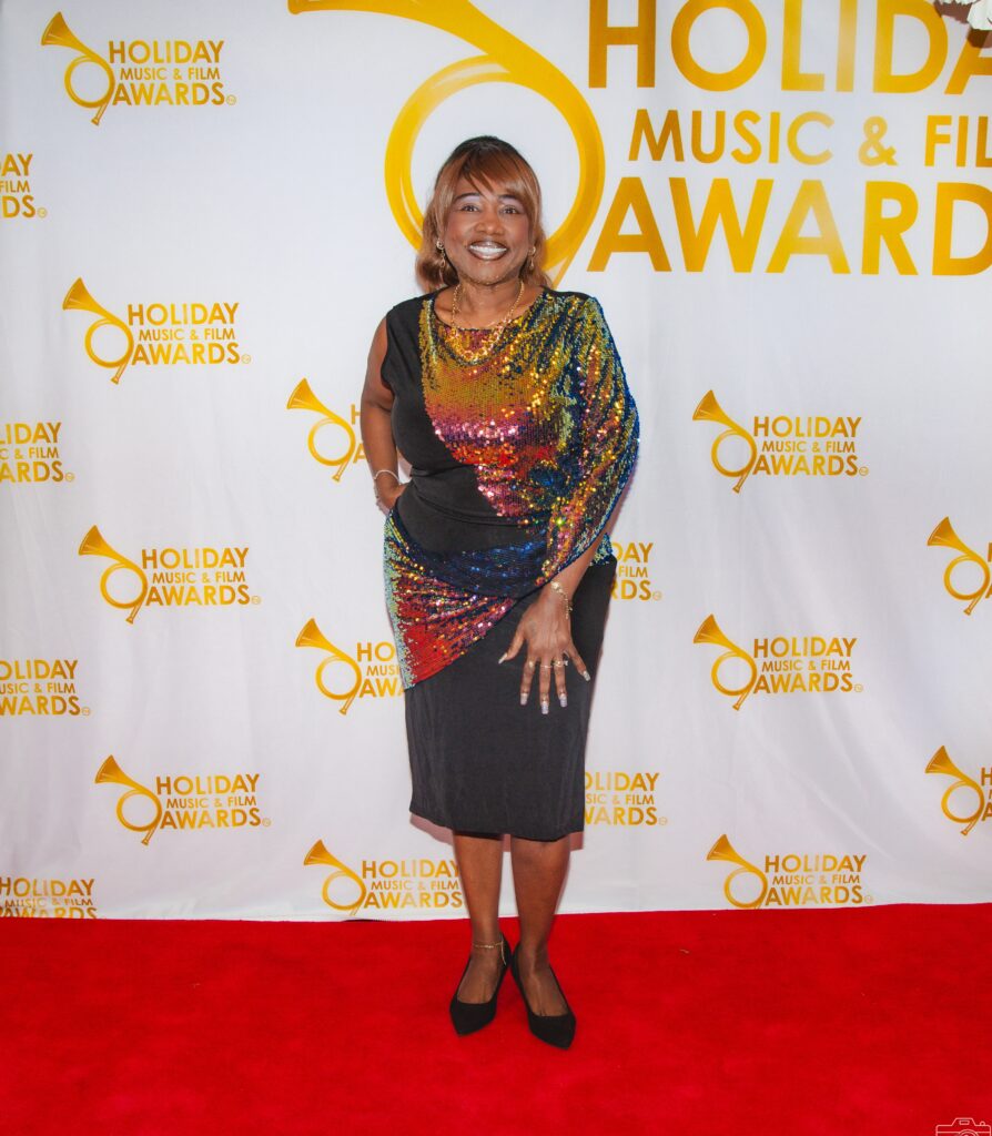 A woman in a colorful dress on the red carpet.