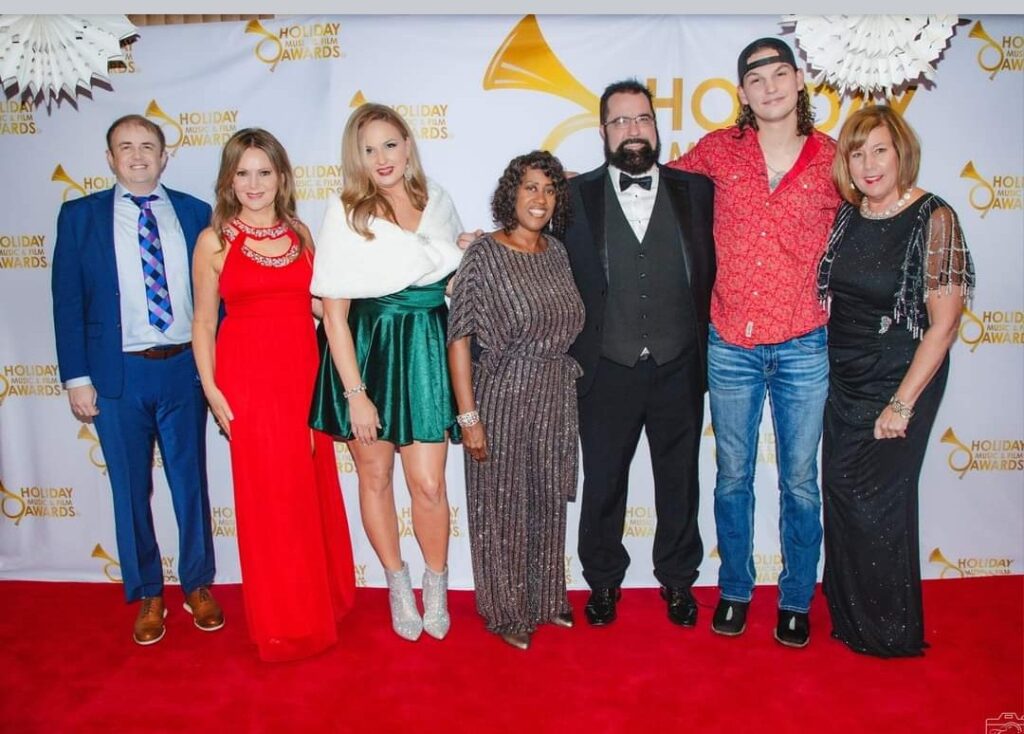 A group of people standing on the red carpet