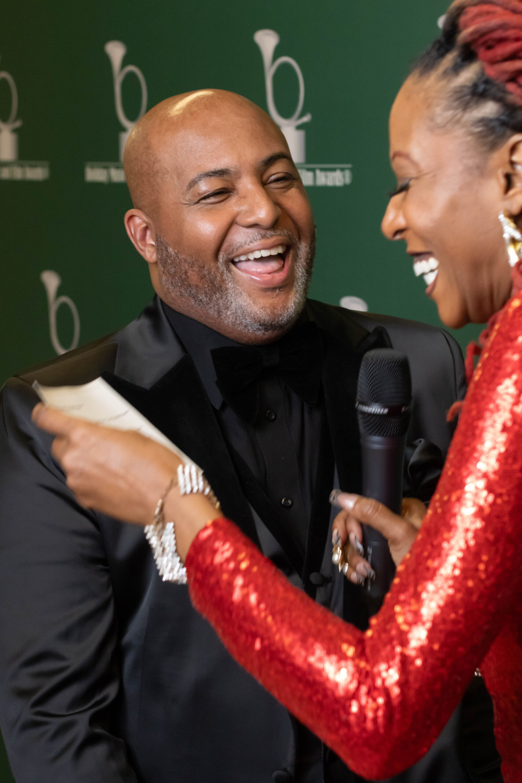 Two people sharing a joyful moment during an event.