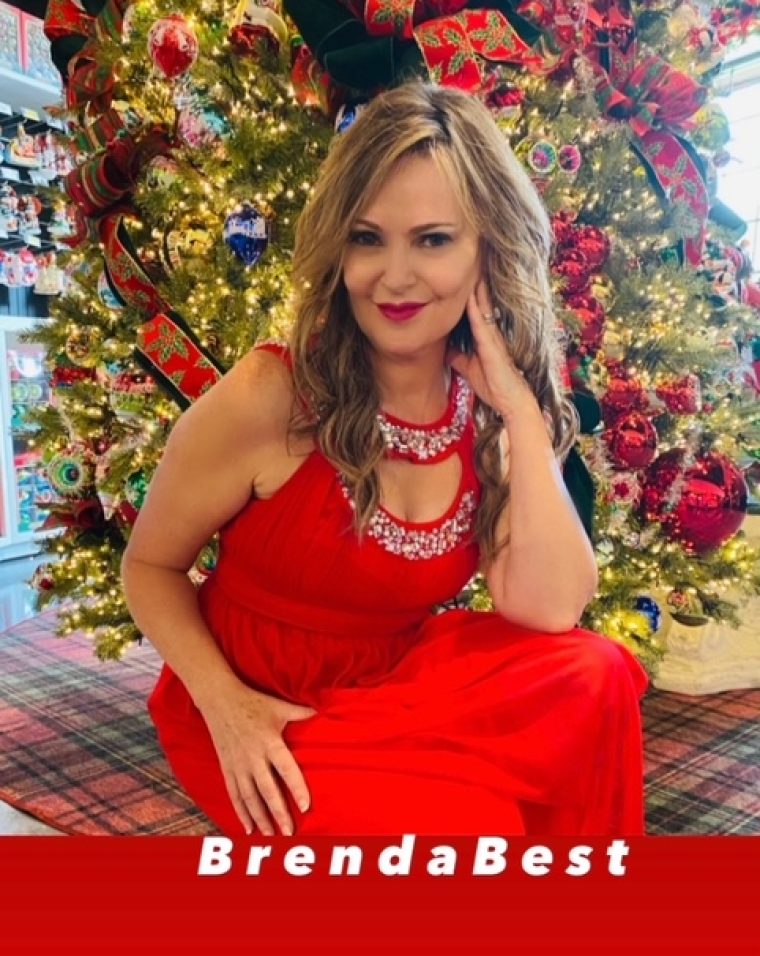 A woman in red dress posing for the camera.